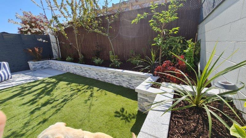 paving slabs garden wall artificial grass sunny